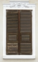 vintage-window-with-wooden-blinds-and-wall-ornament-small