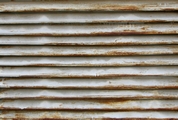 rusty-metal-grate-with-shriveled-white-paint-small